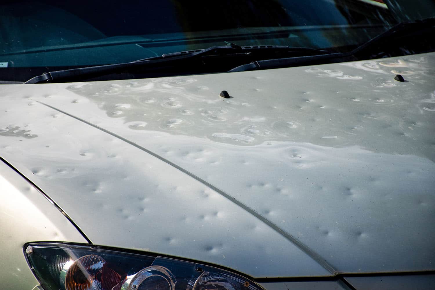 Car hood with multiple dents needing hail damage repair in Montrose, CO